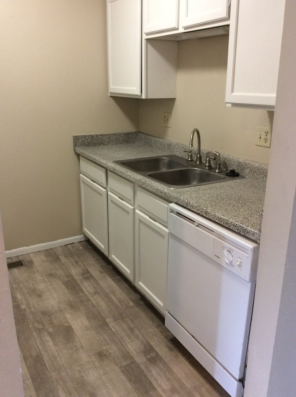 Kitchen in the Yeakel Townhome, featuring white cabinets and a countertop.