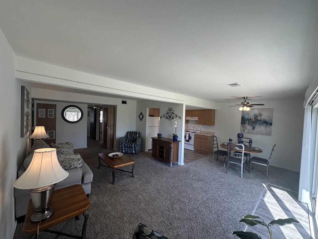 Corner view of the living and dining area in a Park 25 Apartments model unit, showcasing the layout and space.