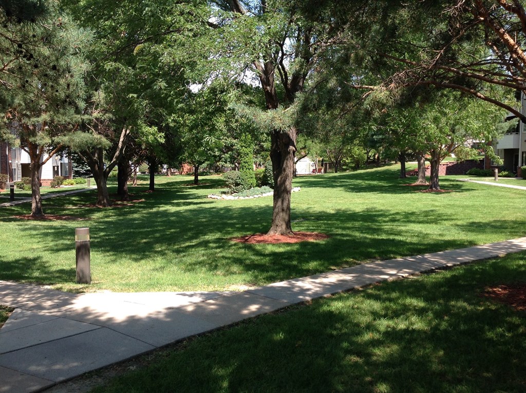 A sidewalk winding through the Muirfield Apartments complex.