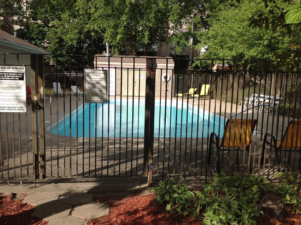 Pool view of an apartment building in the Muirfield Apartments complex.