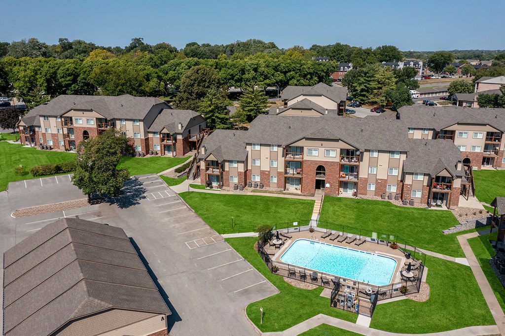 an aerial view of an apartment complex with a swimming pool