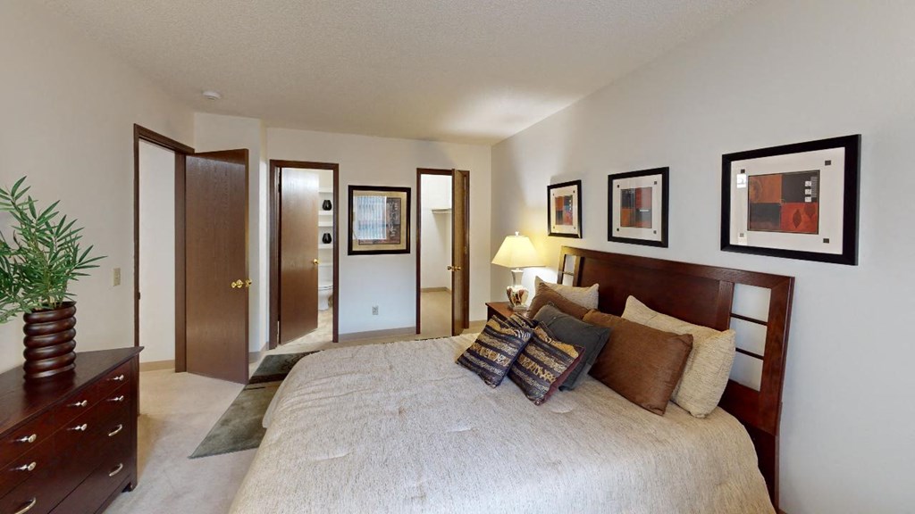 a bedroom with a bed and a dresser