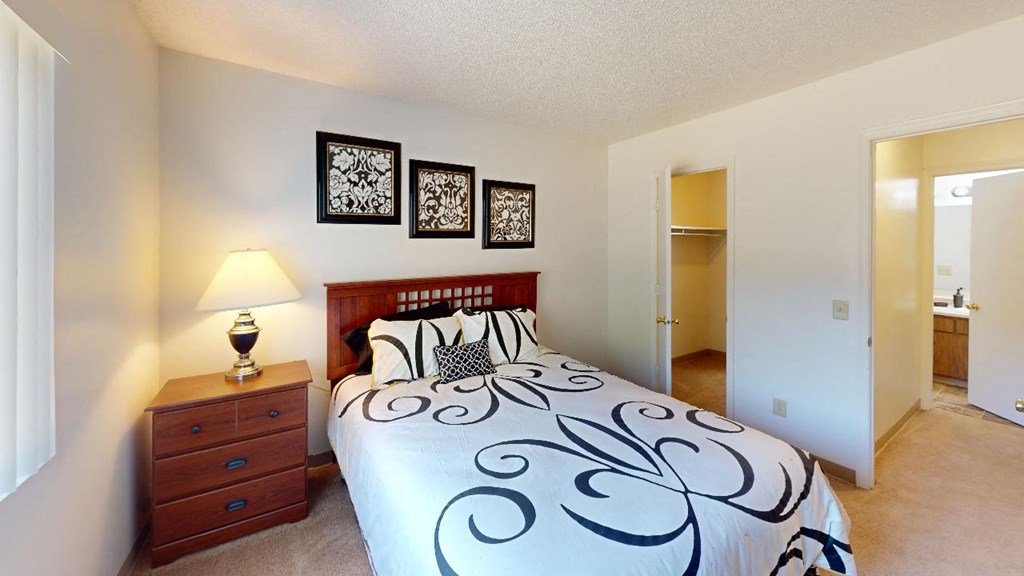 a bedroom with a bed and a dresser