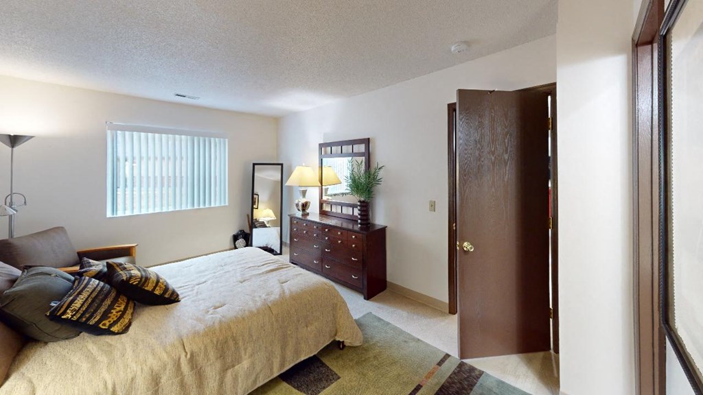 a bedroom with a bed and a dresser