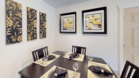 Dining room in a Regency Woods model unit with a wooden table set for four.