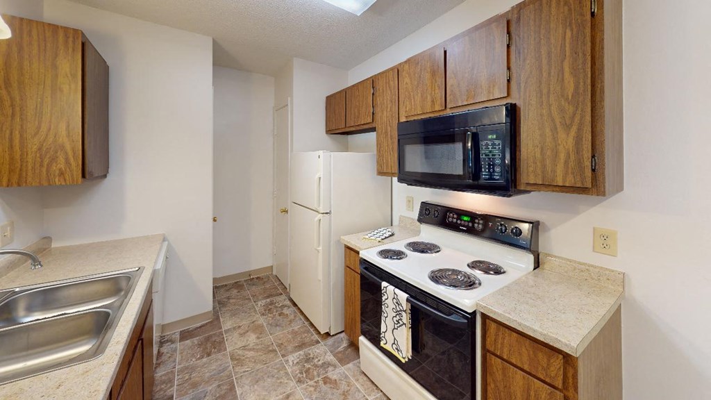a kitchen with a stove microwave and sink