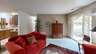 a living room with a red couch and a table