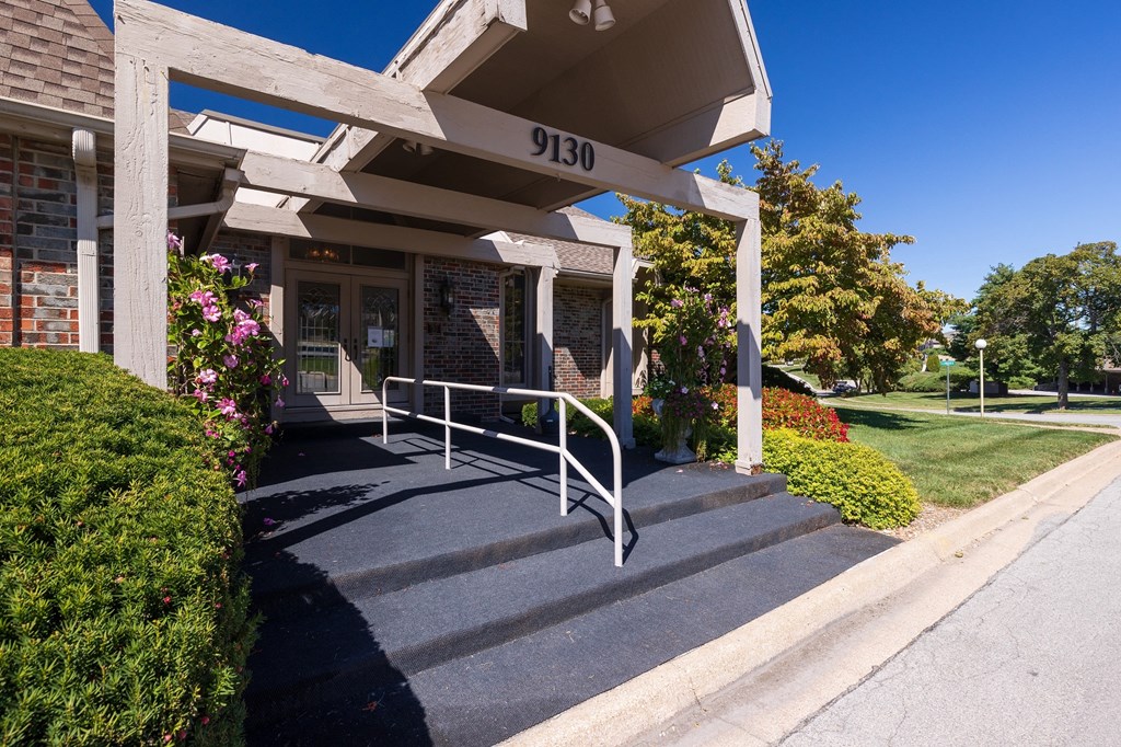 The main entrance of the clubhouse at Regent’s Walk Apartment Homes, featuring a welcoming entryway and landscaped surroundings.