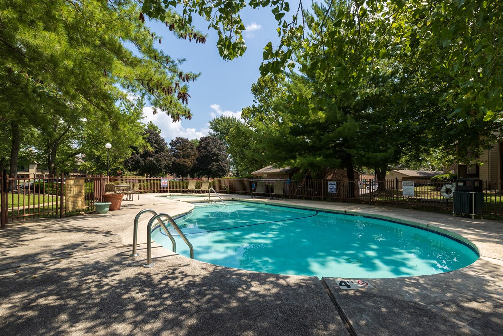 Skyler Ridge Apartments - Poolside View A view of the poolside at Skyler Ridge Apartments, offering a tranquil setting with lounge chairs and refreshing water.