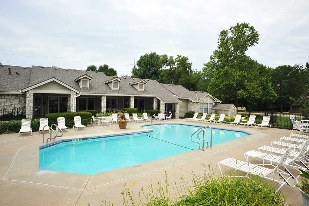 Three Lakes swimming pool, surrounded by well-maintained landscaping and seating for residents to enjoy.