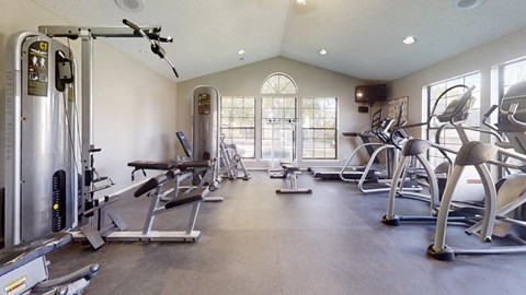 Fitness center at Three Lakes Community with a variety of exercise equipment.