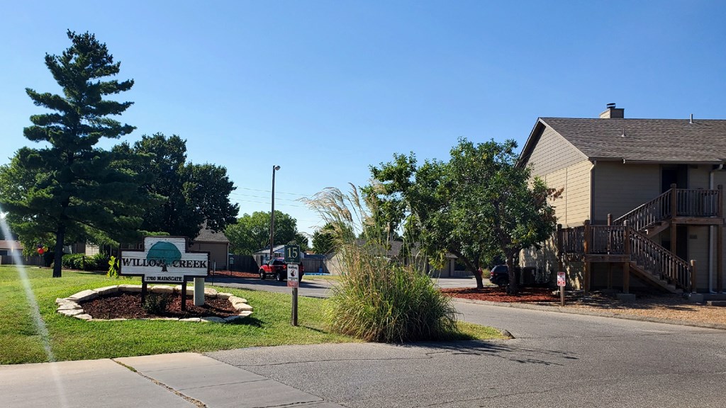 Willow Creek Apartments - Front entrance signage with a welcoming view of the complex.