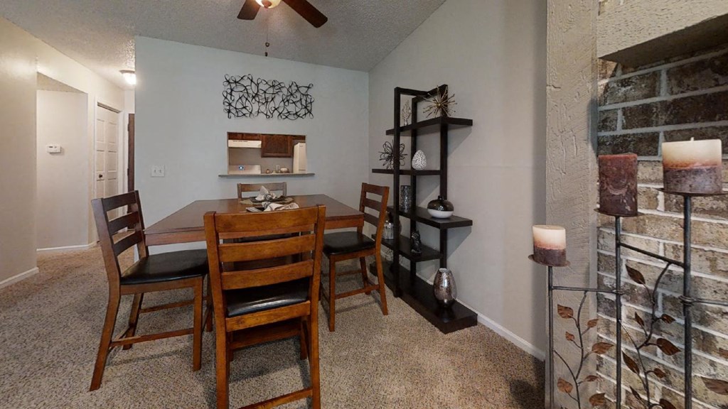 Cozy dining area with a wooden table, matching chairs, and soft lighting, creating a welcoming atmosphere for meals.