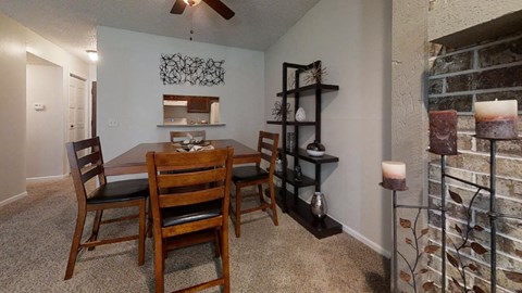 Cozy dining area with a wooden table, matching chairs, and soft lighting, creating a welcoming atmosphere for meals.