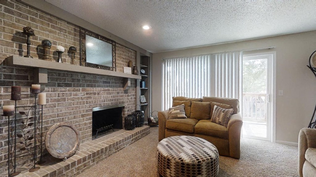 A cozy living room with a love seat, a fireplace, a floor clock, and a round coffee table, softly lit with warm lighting for a relaxing atmosphere.