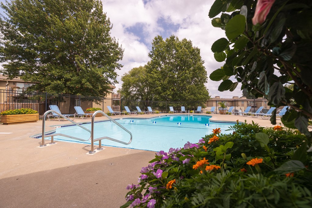 Wilshire swimming pool, surrounded by well-maintained landscaping and seating for residents to enjoy.