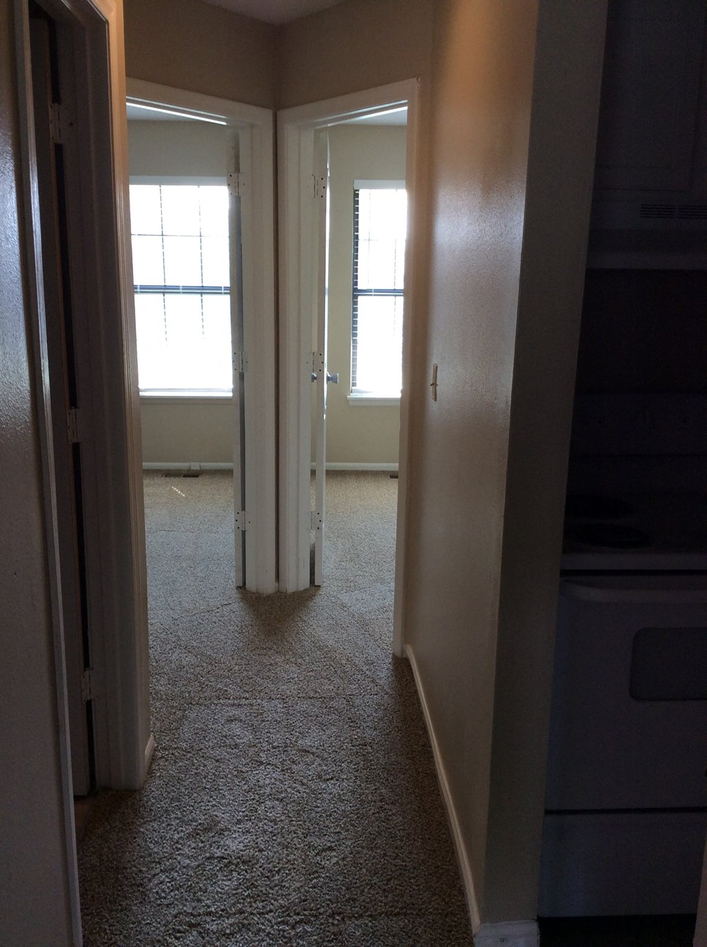 Upper hallway in the Yeakel Townhome, with a door on the left and a window on the right.