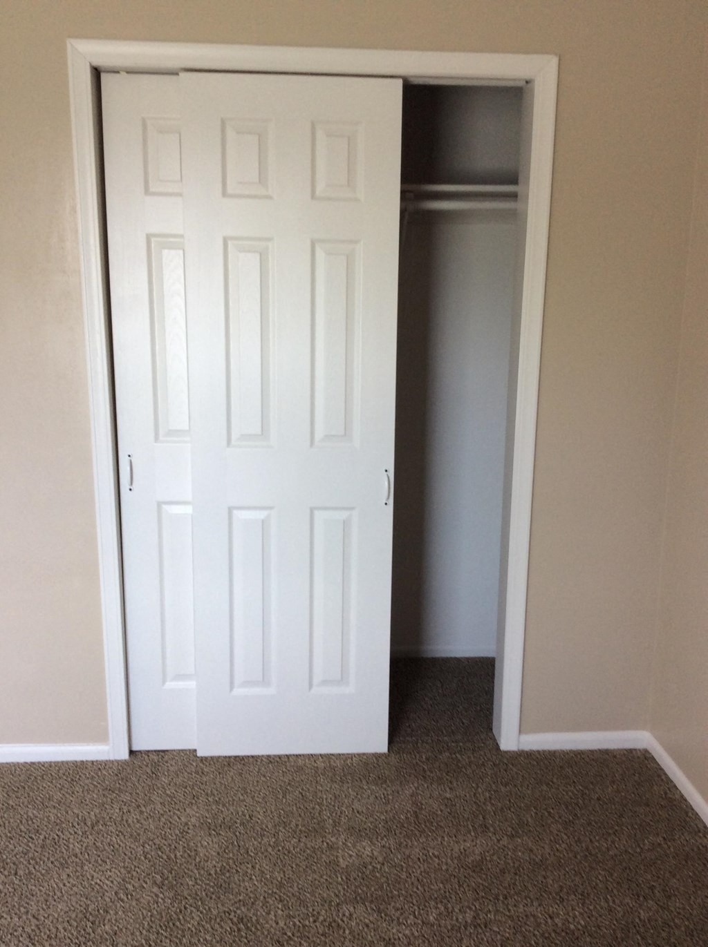 A white bedroom door leading to a closet in the Yeakel Townhome.