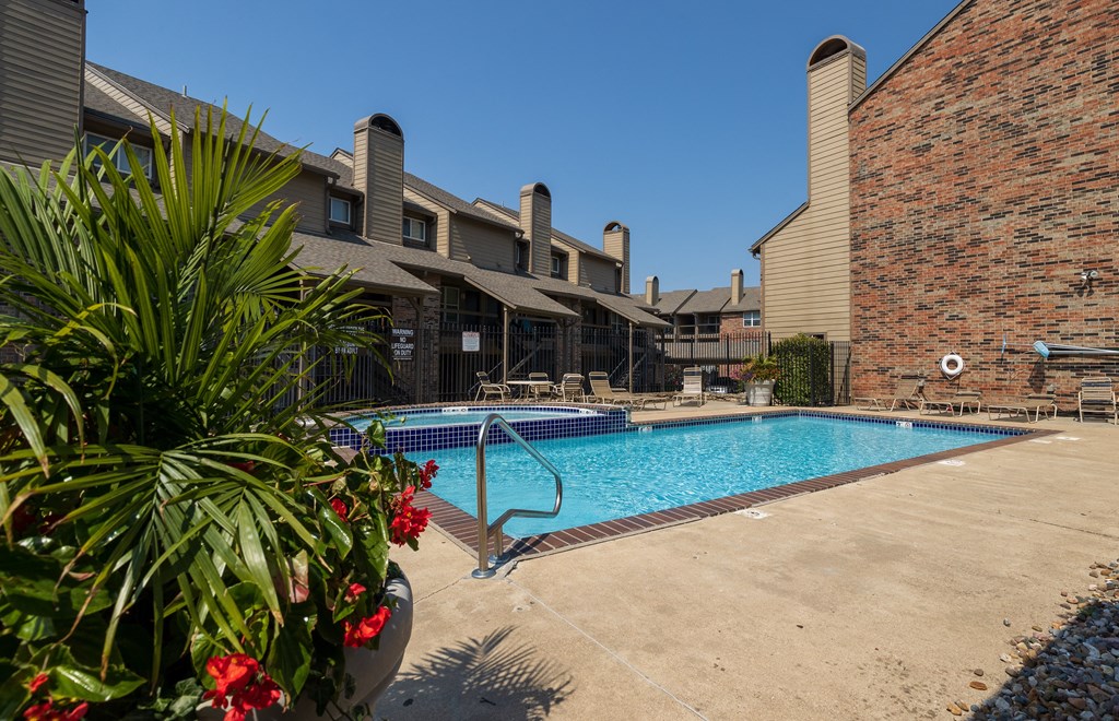 A sparkling pool with lounge chairs and umbrellas for a relaxing afternoon.