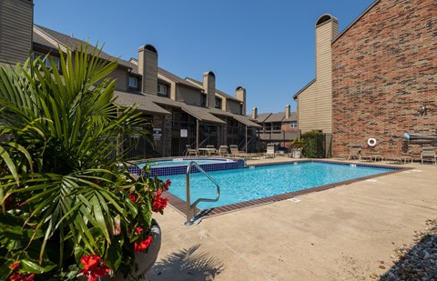 A sparkling pool with lounge chairs and umbrellas for a relaxing afternoon.