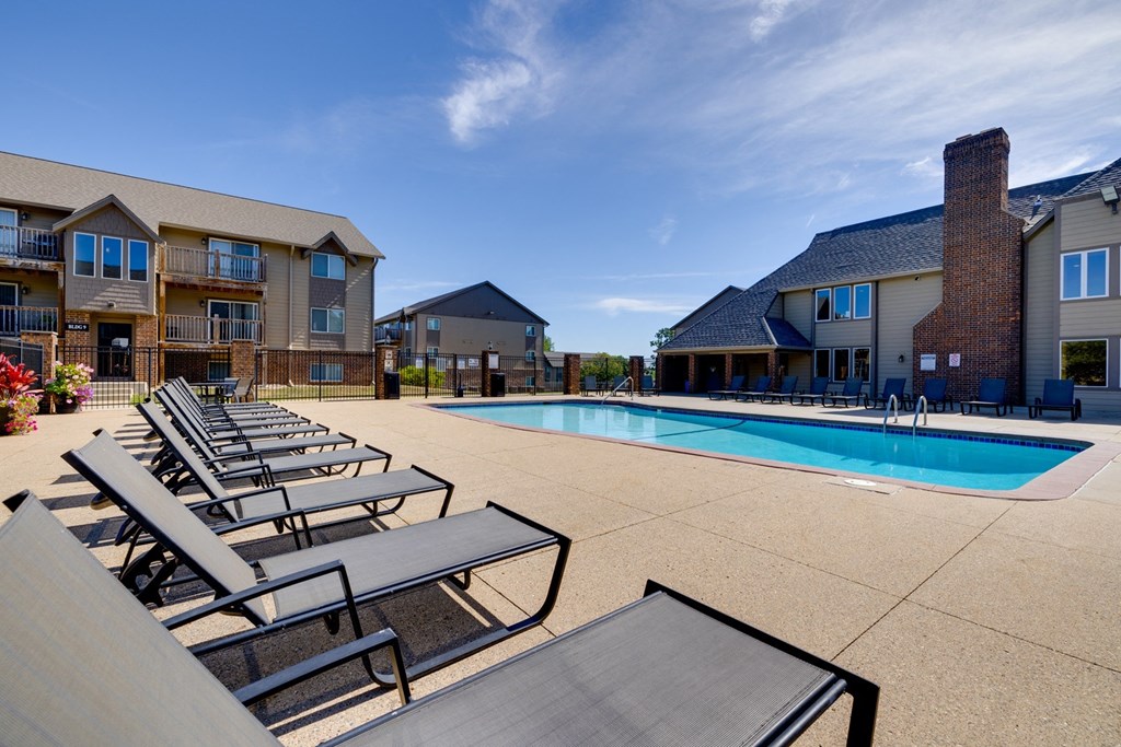 The exterior of the clubhouse, a charming and well-maintained building surrounded by lush landscaping, offering a central gathering place for residents to socialize and enjoy community events.