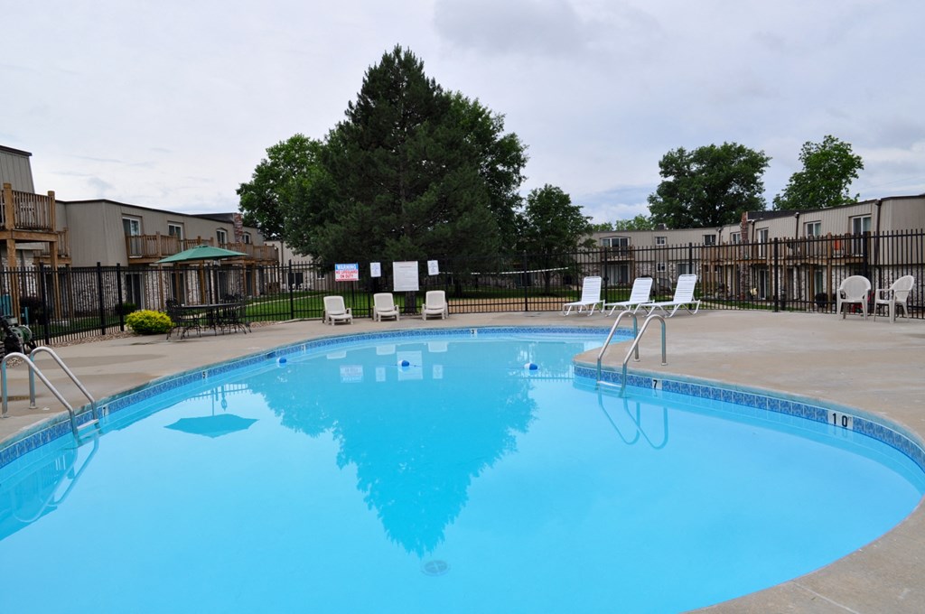 A swimming pool surrounded by lounge chairs, offering a relaxing environment at Park 25 Apartments.