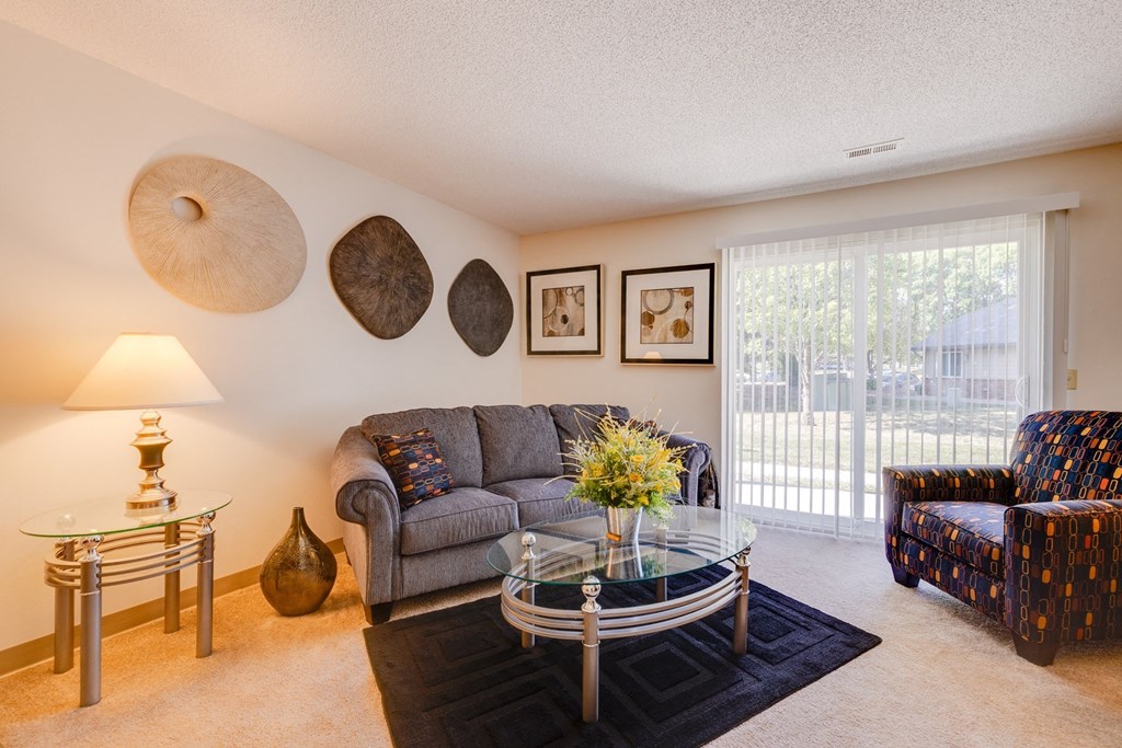a living room with a couch and a glass coffee table