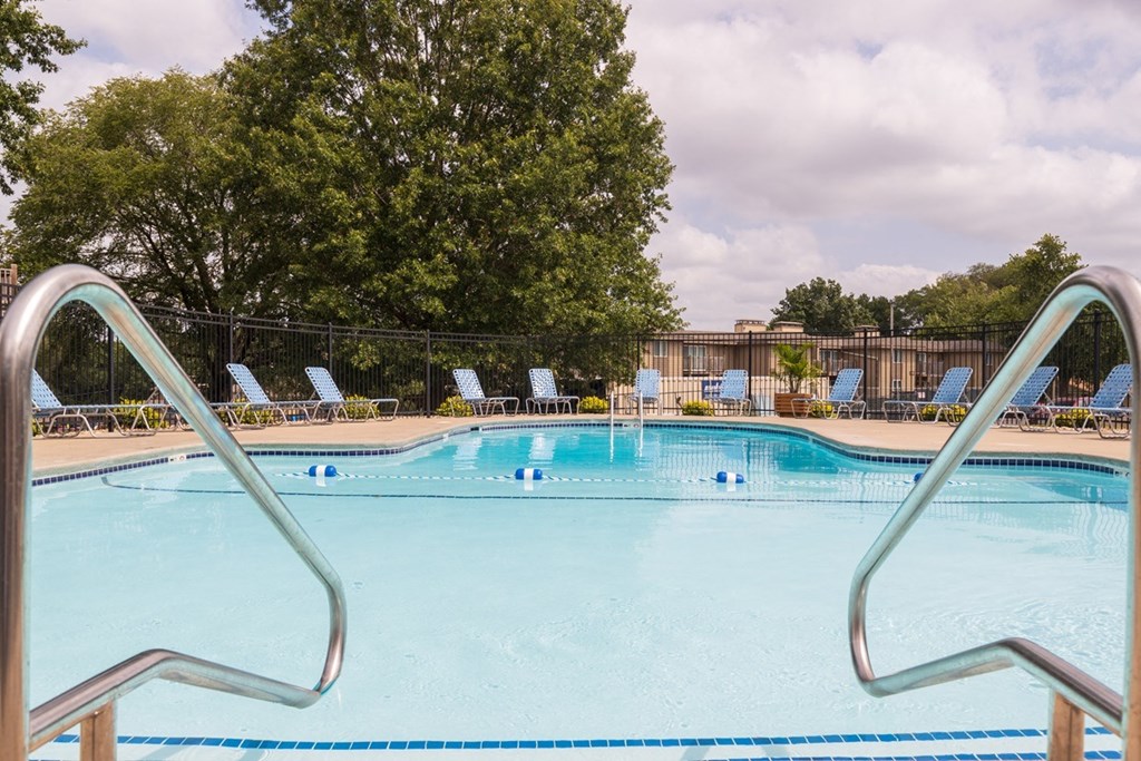 Relaxing pool area at Wilshire, featuring clear blue water and a serene atmosphere for residents.