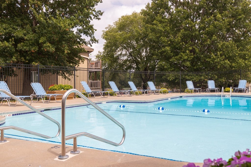 Wilshire swimming pool, surrounded by well-maintained landscaping and seating for residents to enjoy.