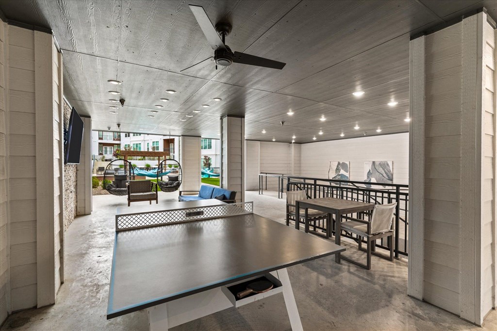 the house has a large dining room with a ping pong table