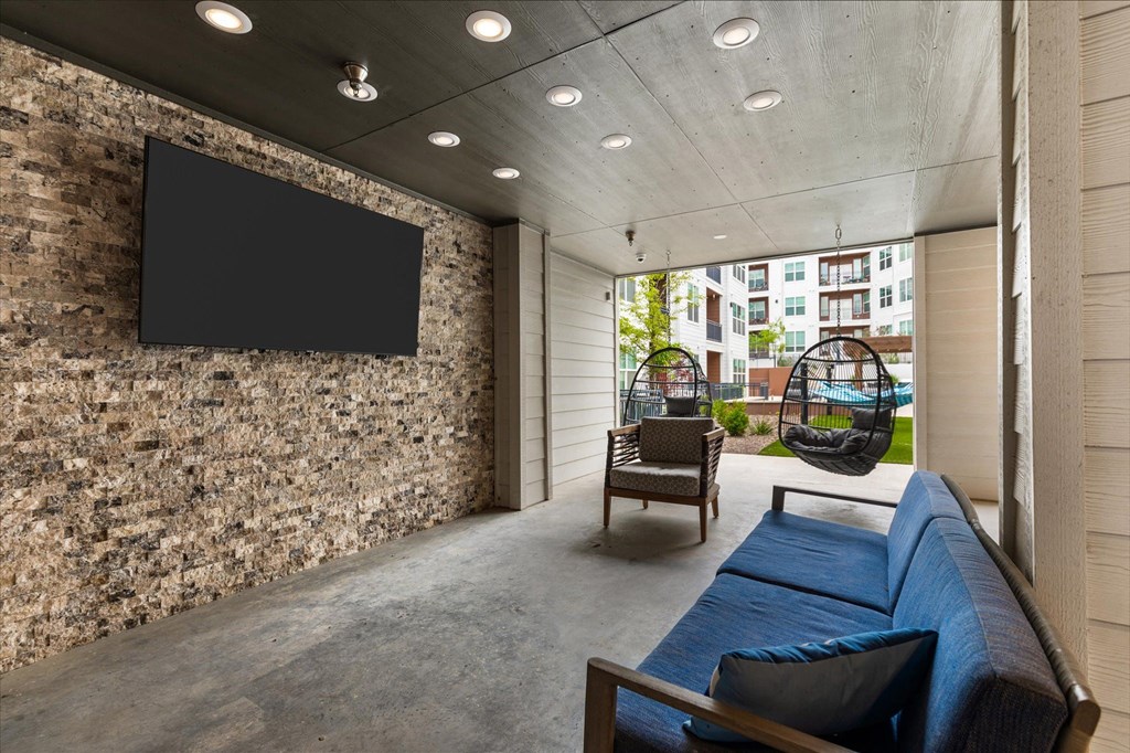 a living room filled with furniture and a flat screen tv