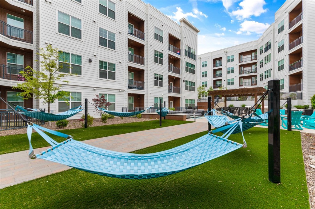 an outdoor hammock area at the bradley braddock road station apartments