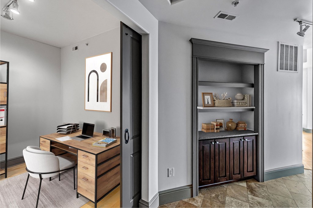 a home office with a desk and a bookshelf