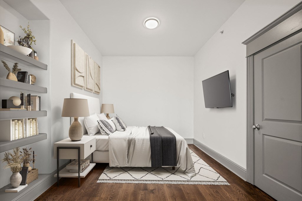 a bedroom with a bed and a tv