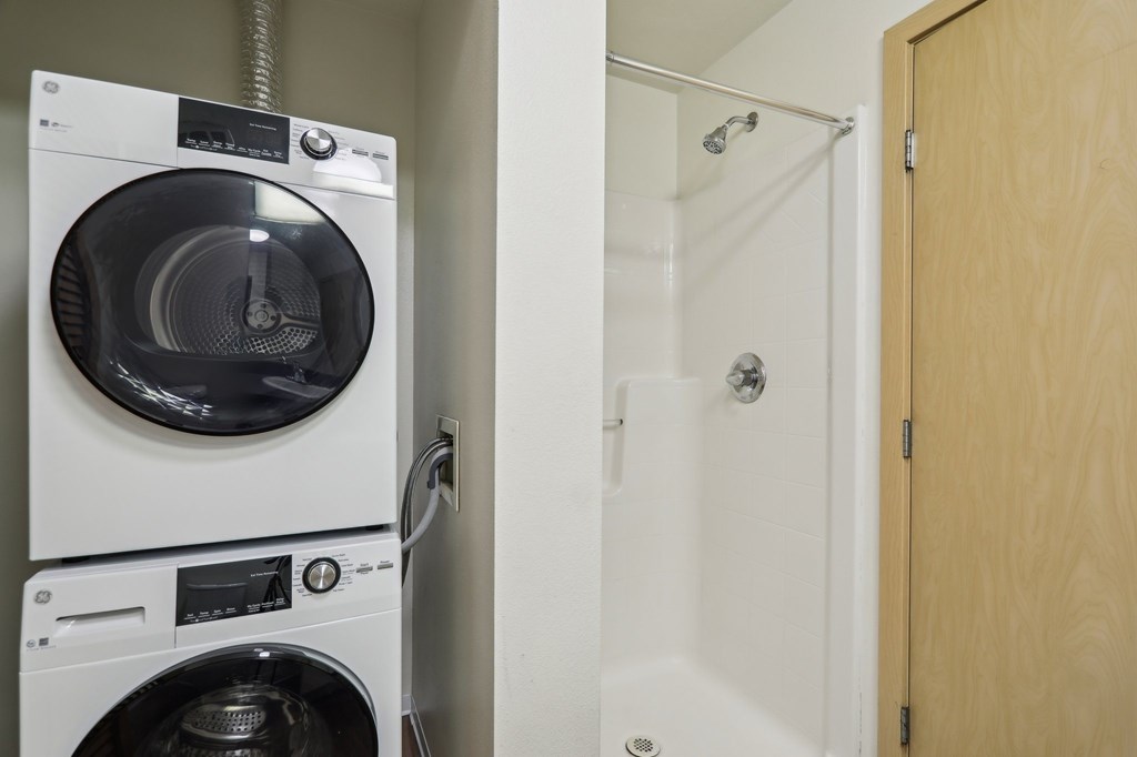 A washing machine and dryer in a small room.