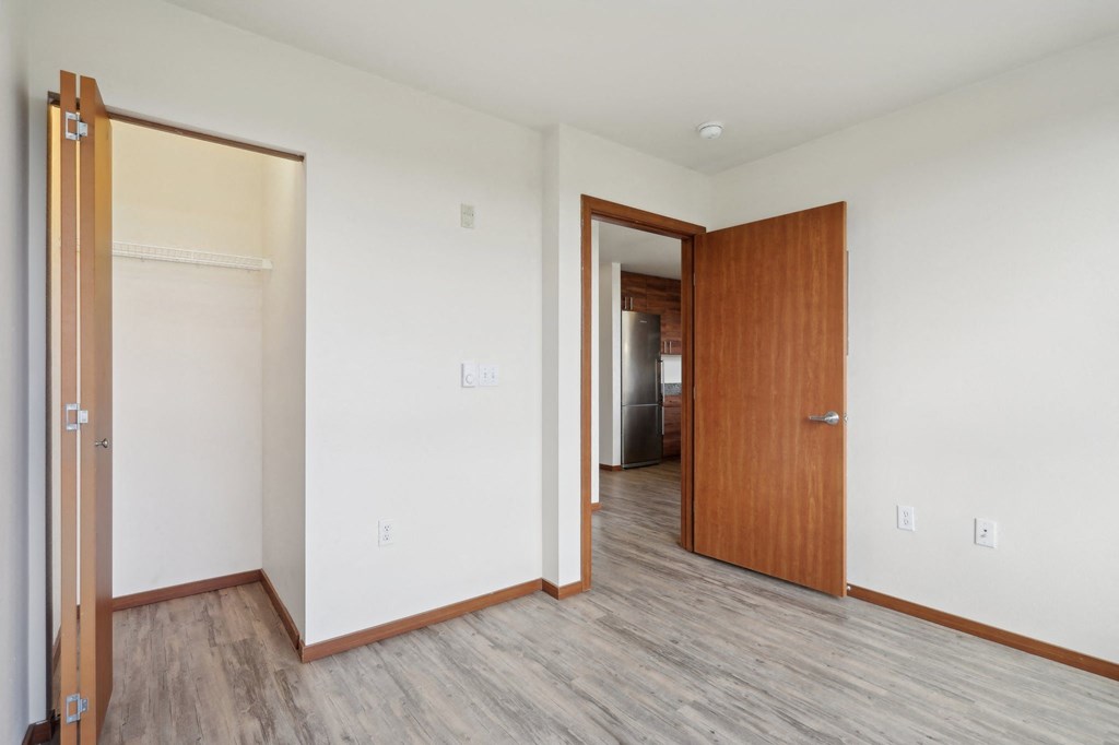 A room with a wooden floor and a wooden door.