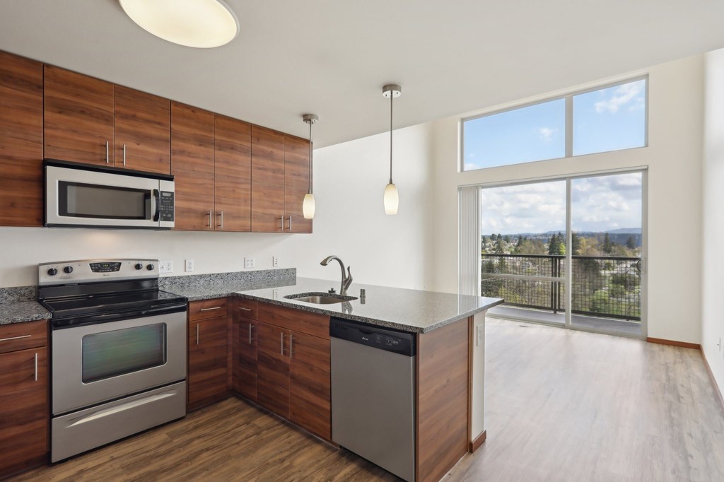 A modern kitchen with wooden cabinets and stainless steel appliances.