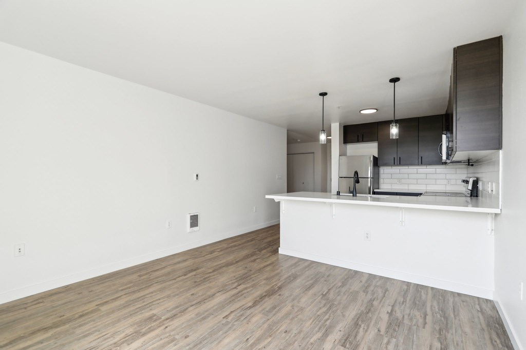 A kitchen area with a countertop and cabinets.
