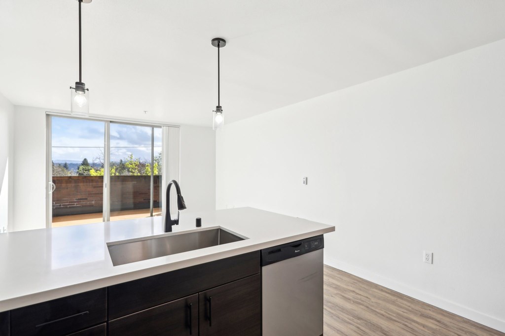 A kitchen with a sink and a window.