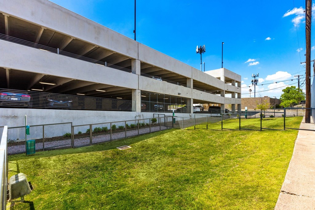 a parking garage with a grassy area in front of it