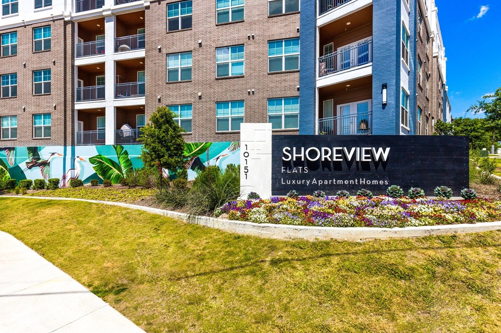 a sign that says shoreview flats in front of a brick building