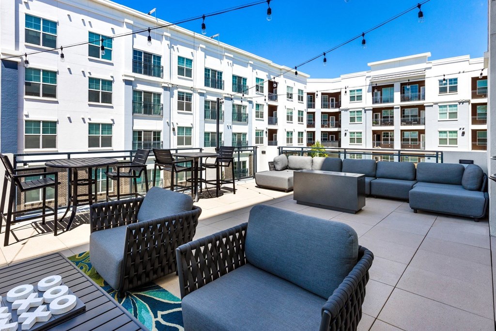 a rooftop patio with couches and tables