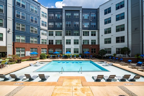 a swimming pool in front of an apartment building