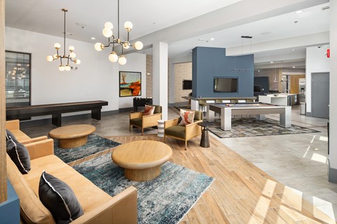 a living room with couches and chairs and a pool table