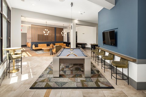 a spacious game room with a pool table and a television
