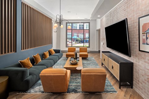 a living room with a couch and chairs and a television