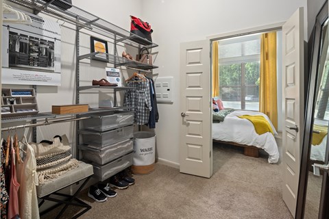 a room with a closet and a bed in the corner