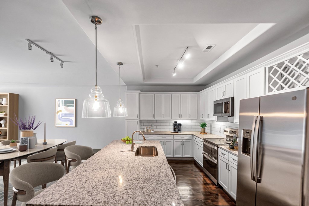 a kitchen with a large island and stainless steel appliances