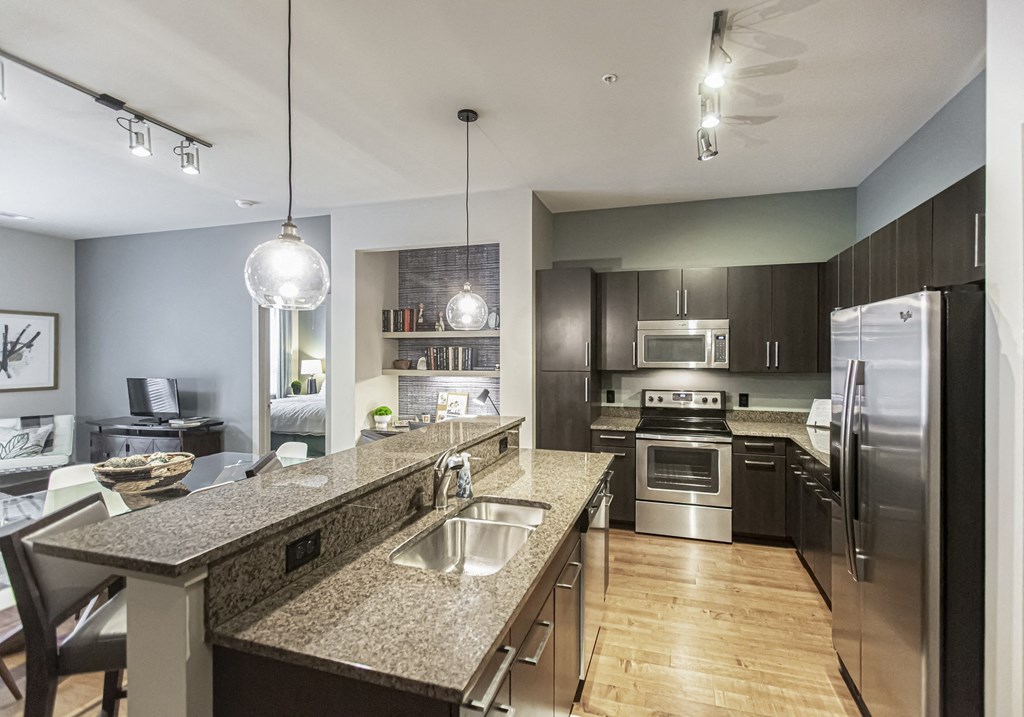 a kitchen with granite counter tops and stainless steel appliances