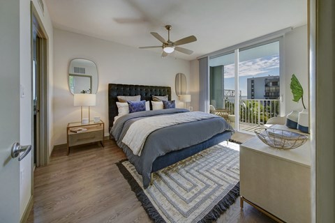 a bedroom with a large bed and a ceiling fan